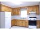 Functional kitchen featuring wooden cabinets and essential appliances at 606 E 4Th Ave, Gastonia, NC 28054