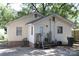 Backyard view of a yellow home with a small porch and concrete area at 606 E 4Th Ave, Gastonia, NC 28054