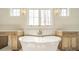 Luxury bathroom with standalone tub, granite countertops, and natural wood cabinets at 608 Deodar Cedar Dr # 69, Matthews, NC 28104
