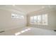 Bright bedroom boasts large windows, neutral paint, carpeted floor, and tray ceiling at 608 Deodar Cedar Dr # 69, Matthews, NC 28104
