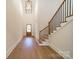 Grand foyer featuring hardwood floors, soaring ceilings, and a staircase with iron balusters at 608 Deodar Cedar Dr # 69, Matthews, NC 28104