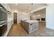 Spacious kitchen with a center island, stainless steel appliances, and a view into the living room at 608 Deodar Cedar Dr # 69, Matthews, NC 28104