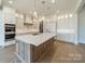 Well-equipped kitchen with ample cabinet space, a center island, and stainless steel appliances at 608 Deodar Cedar Dr # 69, Matthews, NC 28104