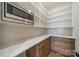 Walk-in pantry with custom shelving, counter space, a microwave and cabinet storage at 608 Deodar Cedar Dr # 69, Matthews, NC 28104