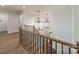 Elegant staircase features wood treads, black metal railing, and decorative chandeliers at 608 Deodar Cedar Dr # 69, Matthews, NC 28104