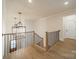 Elegant staircase features wood treads, black metal railing, and decorative chandeliers at 608 Deodar Cedar Dr # 69, Matthews, NC 28104