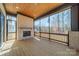 Enclosed porch with brick fireplace, wood flooring and ceiling, and large windows with scenic views at 608 Deodar Cedar Dr # 69, Matthews, NC 28104