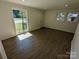 Bright living room featuring hardwood floors, large windows, and neutral paint at 631 Chipley Ave, Charlotte, NC 28205