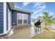 Cozy back patio with a grill, brick accents, and a view of the yard at 705 Hinterland Ln, Matthews, NC 28104