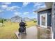 Backyard features a grill with a view of the houses in the neighborhood at 705 Hinterland Ln, Matthews, NC 28104