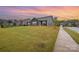 Backyard view of the house, highlighting the extensive lawn and landscaping at 705 Hinterland Ln, Matthews, NC 28104