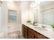 Bright bathroom featuring a double vanity with modern fixtures and wood-look floors at 705 Hinterland Ln, Matthews, NC 28104