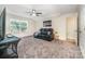 Spacious bonus room featuring a comfortable black leather sofa and ample lighting at 705 Hinterland Ln, Matthews, NC 28104