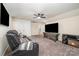 Comfortable bonus room has a sofa, flat screen television and electric fireplace at 705 Hinterland Ln, Matthews, NC 28104