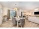 Stylish dining room with modern lighting and seating, connected to an open-concept living space at 705 Hinterland Ln, Matthews, NC 28104