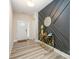 Elegant entryway with a decorative black accent wall, wood flooring and a modern gold console table at 705 Hinterland Ln, Matthews, NC 28104