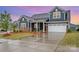 Charming two-story home with a landscaped yard, brick accents, and an attached garage at 705 Hinterland Ln, Matthews, NC 28104