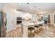 Modern kitchen with white cabinets, granite countertops, stainless steel appliances, and a large island at 705 Hinterland Ln, Matthews, NC 28104