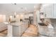 Well-appointed kitchen with a large island, stainless steel appliances, granite countertops and wood-look flooring at 705 Hinterland Ln, Matthews, NC 28104