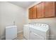 Functional laundry room includes a washer, dryer, freezer, and cabinet storage at 705 Hinterland Ln, Matthews, NC 28104