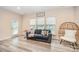 Bright living room with wood floors, a comfortable couch, and a cozy egg chair at 705 Hinterland Ln, Matthews, NC 28104