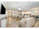 Spacious living room seamlessly connects to the kitchen and dining areas, wood floors and ample natural light at 705 Hinterland Ln, Matthews, NC 28104