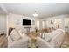 Bright living room with neutral tones, plush sofas, decorative accents, and wood-look flooring at 705 Hinterland Ln, Matthews, NC 28104