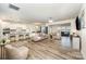 Spacious open-concept living room featuring wood floors, modern furniture, and a bright, airy ambiance at 705 Hinterland Ln, Matthews, NC 28104