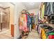 Walk-in closet showcasing organized clothing racks, shelves, and access to the bathroom at 705 Hinterland Ln, Matthews, NC 28104