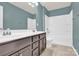 Updated bathroom features a double sink vanity, tiled flooring, and a shower-tub combo at 7101 Agnew Dr, Charlotte, NC 28273