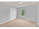 Bedroom with carpet, window, and a double door closet at 7101 Agnew Dr, Charlotte, NC 28273