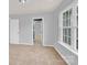Spacious, carpeted bedroom with a doorway leading to the ensuite bathroom at 7101 Agnew Dr, Charlotte, NC 28273
