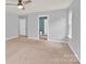 Carpeted bedroom with ensuite bathroom, window, and neutral gray walls at 7101 Agnew Dr, Charlotte, NC 28273