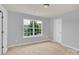 Bright bedroom with a window showing green trees at 7101 Agnew Dr, Charlotte, NC 28273