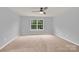 This bedroom has neutral paint, carpet and a window at 7101 Agnew Dr, Charlotte, NC 28273