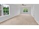This bright bedroom features neutral paint, carpet and a large window with exterior views at 7101 Agnew Dr, Charlotte, NC 28273
