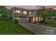 Two-story home shows inviting exterior with stone accents, landscaped front yard, and attached two-car garage at 7101 Agnew Dr, Charlotte, NC 28273