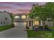Well-maintained two-story home featuring stone accents, manicured lawn, and an attached two-car garage at 7101 Agnew Dr, Charlotte, NC 28273