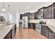 Kitchen with stainless steel appliances, dark wood cabinets and granite countertops with dining bar at 7101 Agnew Dr, Charlotte, NC 28273