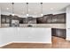 Modern kitchen featuring dark cabinets, granite countertops, stainless steel appliances and a breakfast bar at 7101 Agnew Dr, Charlotte, NC 28273