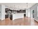 Bright kitchen area featuring stainless steel appliances, dark cabinetry, pendant lighting and an adjacent dining area at 7101 Agnew Dr, Charlotte, NC 28273