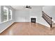 Large living room with hardwood floors, a fireplace, and a staircase at 7101 Agnew Dr, Charlotte, NC 28273