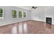 Spacious living room featuring hardwood floors, a cozy fireplace, and large windows at 7101 Agnew Dr, Charlotte, NC 28273
