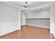 A view of an empty room featuring wood floors, gray walls, white trim, and an ornate chandelier at 7101 Agnew Dr, Charlotte, NC 28273