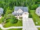 Aerial view of a charming home with manicured lawns and a paved driveway at 7480 Katelyn Ct, Harrisburg, NC 28075