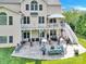 Backyard featuring a patio, upper deck, and lush greenery at 7480 Katelyn Ct, Harrisburg, NC 28075