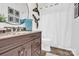Bright bathroom features granite countertop vanity and modern fixtures at 7480 Katelyn Ct, Harrisburg, NC 28075