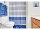 Bathroom with toilet, blue striped shower curtain, and matching towels at 7480 Katelyn Ct, Harrisburg, NC 28075