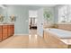 Bright bathroom features a bathtub and double sink vanity at 7480 Katelyn Ct, Harrisburg, NC 28075
