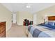 Bright bedroom with desk area, neutral walls, and ceiling fan at 7480 Katelyn Ct, Harrisburg, NC 28075